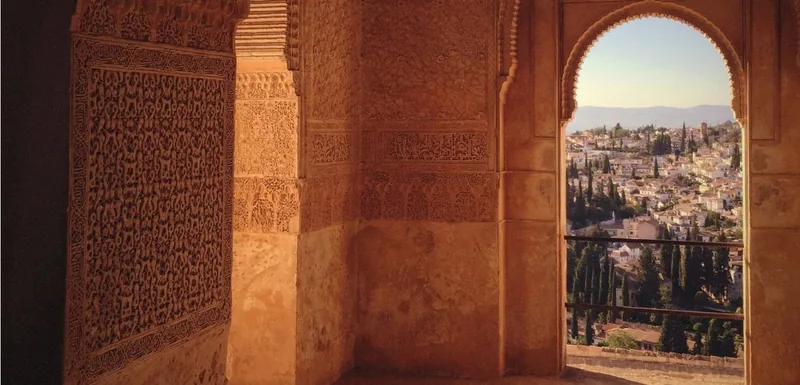 View of Granada through a carved arch at the Alhambra