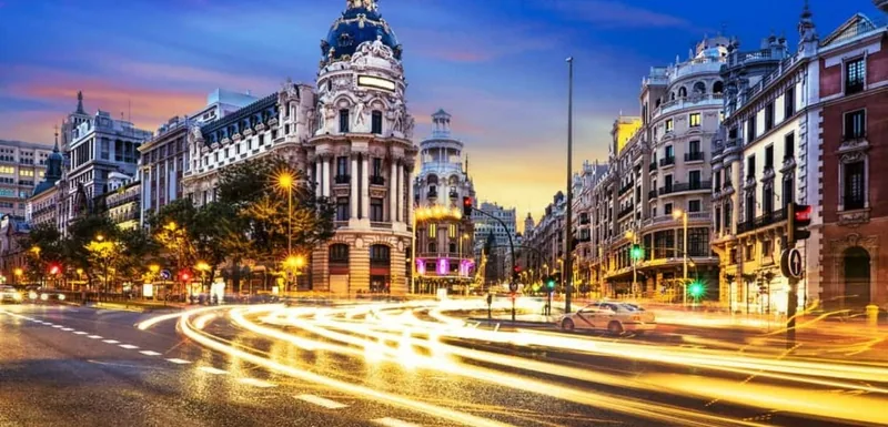 Traffic moving along Gran Vía in Madrid at dusk